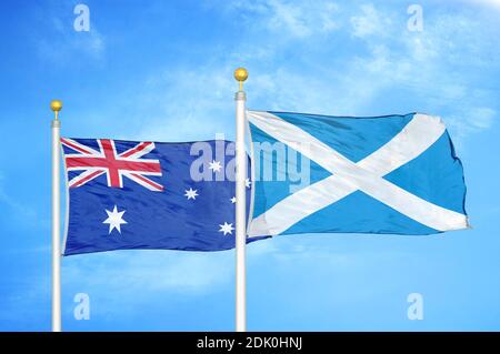 Australia and Scotland two flags on flagpoles and blue cloudy sky Stock Photo