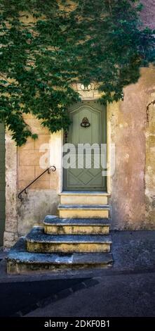 Wooden doors and stairs in Pézenas in the historic old town in summer. Built around the XVI century. Stock Photo