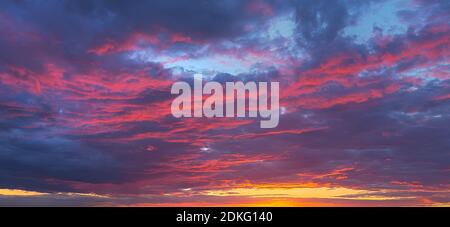 Fantastico gioco di colori e sfumature di viola, scarlatto cielo nuvoloso al tramonto Foto Stock