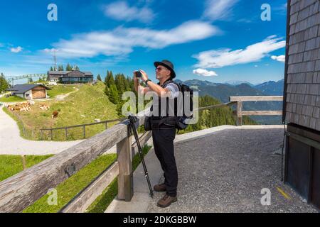 Man taking photos with the smartphone, Wallberg, Rottach-Egern, Tegernsee, Bavarian Alps, Bavaria, Germany, Europe Stock Photo