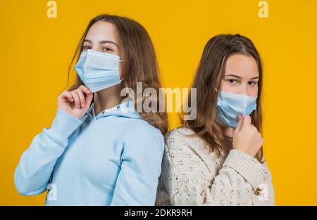 teen girls wear respirator mask while coronavirus pandemic quarantine, avoid contact. Stock Photo