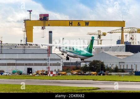 Aer Lingus ATR 72-600 EI-FAS con partenza dall'aeroporto BHD di Belfast City, Irlanda del Nord, passando per Sampson, una delle due iconiche gru a portale giganti a B Foto Stock