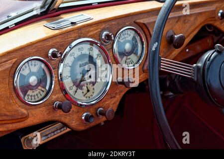 Old classic car wooden dash board and steering wheel. Stock Photo