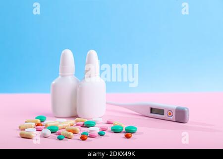 Medical medicines, spray, bottles of nose drops, syrup, vitamins, scattered tablets, capsules Foto Stock