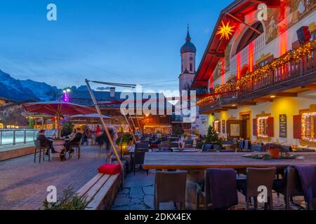 Vista della Chiesa Parrocchiale di San Martino e del bar locale dell'hotel, Garmisch-Partenkirchen, Baviera, Germania Foto Stock