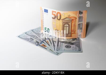 50 Euro note on top of one hundred dollar bills Stock Photo