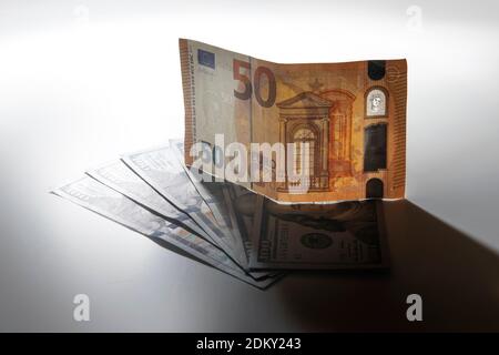 50 Euro note on top of one hundred dollar bills Stock Photo