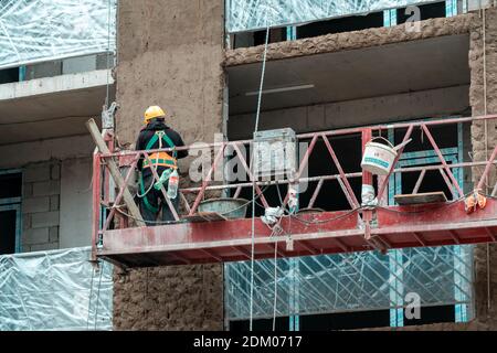 Tbilisi, Georgia - 12 dicembre 2020: Lavoratore in costruzione. Costruzione di una struttura in base ai progressi compiuti in loco. Indossare i dispositivi di sicurezza adeguati Foto Stock