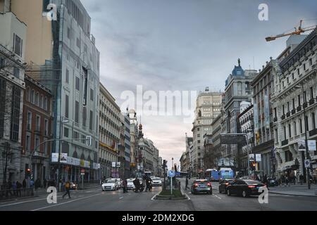 MADRID, SPAIN - MARCH 03, 2020: Famous Calle de Alcalá, one of the oldest and longest streets in Madrid. Typical street life at dusk. Stock Photo
