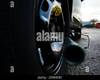 Ruota di scorta montata su un'auto dopo una foratura dello pneumatico originale. La velocità massima consentita per la vettura viene indicata sullo pneumatico. Foto Stock