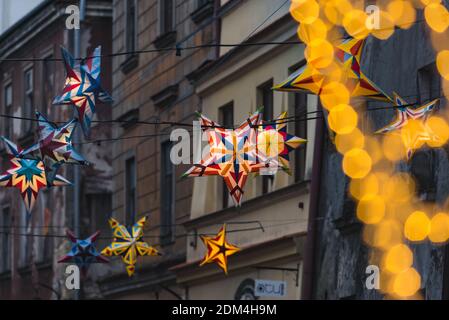 Lublin, Poland - December 29, 2019: Colorful illuminated stars as Christmas decorations at Złota Street in old town Stock Photo