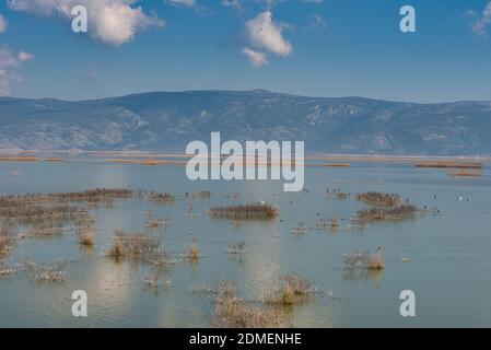 A majestic cloudscape over a calm Karla lake in Greece during the daytime Stock Photo