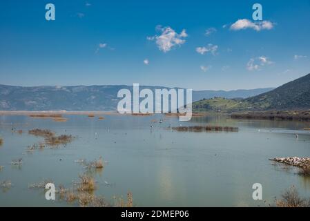 A majestic cloudscape over a calm Karla lake in Greece during the daytime Stock Photo