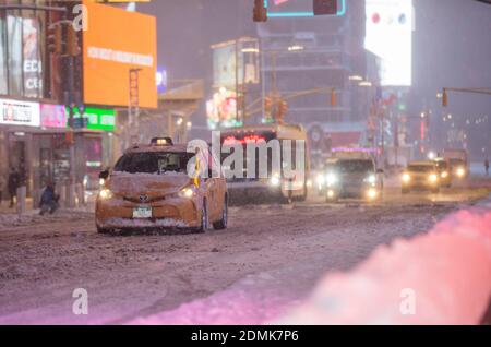 New York, USA. 16th Dec, 2020. Vehicles run on Times Square in New York, the United States, Dec. 16, 2020. A snow storm hit New York on Wednesday. Credit: Wang Ying/Xinhua/Alamy Live News Foto Stock