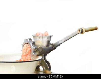 Vintage meat grinder grinds chicken meat isolated on white background Stock Photo