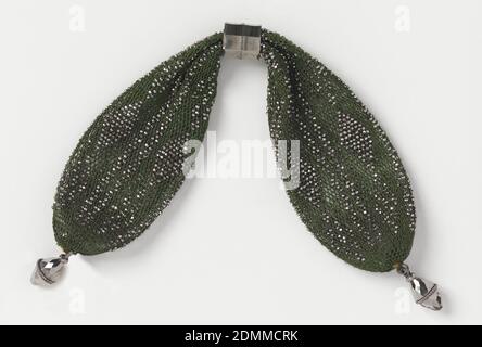 Miser's purse, Medium: silk, steel Technique: crochet, Crocheted dark green silk ornamented with cut steel bands in bar and diamond pattern. An octagonal steel ring controls side closing; faceted steel drops at each end., France, early 19th century, costume & accessories, Miser's purse Stock Photo