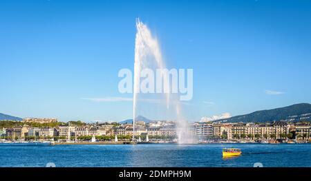 The bay of Geneva with the Jet d'Eau water jet fountain and a Mouettes Genevoises water bus. Stock Photo