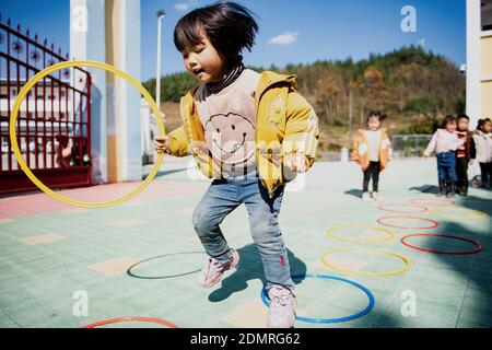 (201217) -- BEIJING, Dec. 17, 2020 (Xinhua) -- A child plays at a kindergarten in Yandongjiao Village of Zhenxiong County, southwest China's Yunnan Province, Nov. 11, 2020.  The year 2020 is a juncture where China is wrapping up the plan for the 2016-2020 period and preparing for its next master plan.    In 2020, China stepped up efforts to shore up weak links regarding people's livelihoods. A slew of measures has been rolled out to address people's concerns in employment, education, basic medical services, the elderly care, housing, public services, etc. (Xinhua/Wang Guansen) Stock Photo