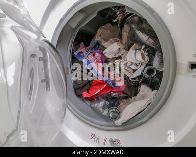 Washing machine filled with plastic waste representing micro plastic waste pollution during laundry Stock Photo