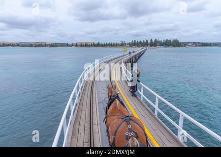 VICTOR HARBOR, AUSTRALIA, JANUARY 5, 2020: Horse drawn tram on a wooden causeway at Victor Harbor, Australia Stock Photo