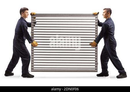 Workers carrying a silver metal grill door isolated on white background Foto Stock