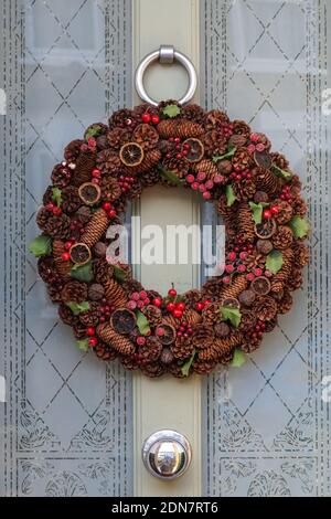 Corona di Natale decorativa su una porta d'ingresso, Londra Inghilterra Regno Unito Foto Stock