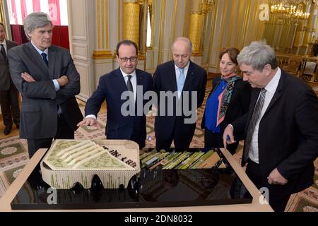 Alain Berger (R), the Commissioner General of the French Pavilion at Expo Milan 2015 presents a model of Pavillon France to (L-R) French Minister of Agriculture Stephane Le Foll, President Francois Hollande, Minister of Foreign Affairs Laurent Fabius and Minister of Ecology Segolene Royal, at the Elysee Palace in Paris, France on March 18, 2015. Photo by Gilles Rolle/Pool/ABACAPRESS.COM Stock Photo