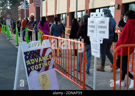 Marietta, GA, USA. 17th Dec, 2020. Residents in Cobb County, Georgia brave cold weather and long waits to cast in-person ballots as early voting opened this week for the January 5, 2021 special election for two senators. With three weeks left before polls close in two U.S. Senate runoff elections in Georgia that will determine the balance of power in Washington, a record number of early voters cast their ballots in person in multiple counties, according to reports. Following close races in November, Democrats Raphael Warnock and Jon Ossoff are hoping they unseat incumbent Republican Sens. Stock Photo