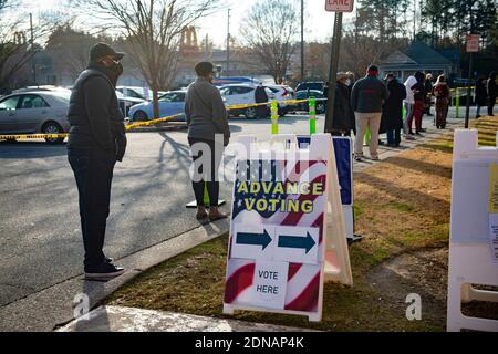 Marietta, GA, USA. 17th Dec, 2020. Residents in Cobb County, Georgia brave cold weather and long waits to cast in-person ballots as early voting opened this week for the January 5, 2021 special election for two senators. With three weeks left before polls close in two U.S. Senate runoff elections in Georgia that will determine the balance of power in Washington, a record number of early voters cast their ballots in person in multiple counties, according to reports. Following close races in November, Democrats Raphael Warnock and Jon Ossoff are hoping they unseat incumbent Republican Sens. Stock Photo