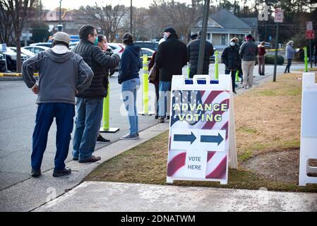 Marietta, GA, USA. 17th Dec, 2020. Residents in Cobb County, Georgia brave cold weather and long waits to cast in-person ballots as early voting opened this week for the January 5, 2021 special election for two senators. With three weeks left before polls close in two U.S. Senate runoff elections in Georgia that will determine the balance of power in Washington, a record number of early voters cast their ballots in person in multiple counties, according to reports. Following close races in November, Democrats Raphael Warnock and Jon Ossoff are hoping they unseat incumbent Republican Sens. Stock Photo