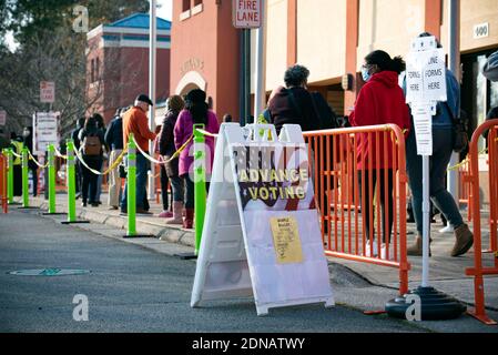 Marietta, GA, USA. 17th Dec, 2020. Residents in Cobb County, Georgia brave cold weather and long waits to cast in-person ballots as early voting opened this week for the January 5, 2021 special election for two senators. With three weeks left before polls close in two U.S. Senate runoff elections in Georgia that will determine the balance of power in Washington, a record number of early voters cast their ballots in person in multiple counties, according to reports. Following close races in November, Democrats Raphael Warnock and Jon Ossoff are hoping they unseat incumbent Republican Sens. Stock Photo