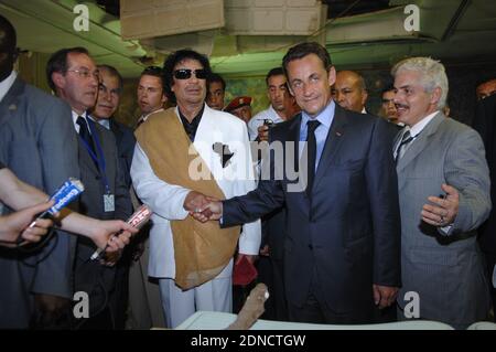 Libya's President Moammar Gadhafi (L) greets his French counterpart Nicolas Sarkozy and Claude Gueant at Bab Azizia Palace in Tripoli, Libya on July 25, 2007. Sarkozy met Gadhafi on Wednesday on a trip to deepen relations after helping to resolve a diplomatic standoff that hurt the oil exporter's ties with the West. Photo by Christophe Guibbaud/ABACAPRESS.COM Stock Photo