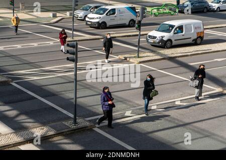 LISBON, PORTUGAL - Dec 15, 2020: People crossing a street on a zebra crossing in front of the Vasco da Gama shopping Mall Stock Photo