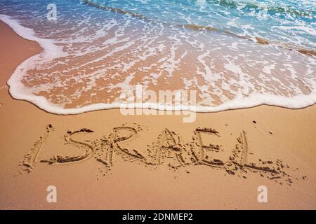 La parola Israele sulla spiaggia di sabbia. Iscrizione Israele sul mare con un'onda Foto Stock