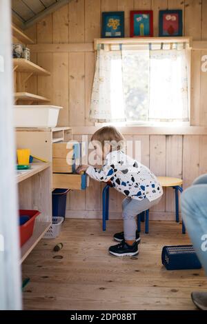 Toddler girl in playhouse Stock Photo