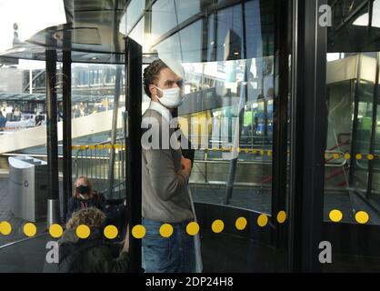 Extinction Rebellion environmental activists fiction their hands with super glue on the door glass protest blocks the terminals access of the Amsterda Stock Photo