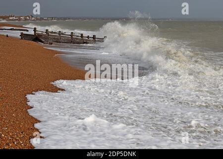 Vecchi groynes intemperie che proteggono la spiaggia di Pevensey Bay sulla costa meridionale dell'Inghilterra. Senza groynes la spiaggia soffrirebbe di erosione. Foto Stock