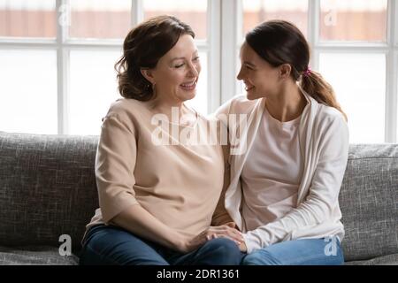 Felice madre di mezza età e figlia di grunnup che tiene le mani Foto Stock