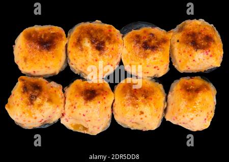 Set di panini al sushi al forno isolati su sfondo nero. Rotolo di sushi al forno isolato. Cibo tradizionale giapponese con pezzi di sushi deliziosi maki Foto Stock
