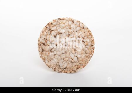 Fetta rotonda di pane di riso fresco e arioso di grano saraceno isolato su sfondo bianco. Foto Stock