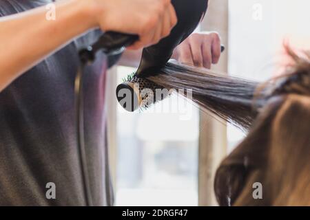 asciugare con un getto d'aria sulla spazzola rotonda Foto Stock