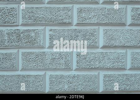 Texture parete di calcestruzzo con piccoli fori. Sfondo carta da parati una parete di cemento in forma di pietre con micro fori. Muro di pietra con fori Foto Stock