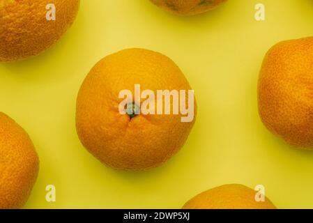 I tangerini si avvicinano su uno sfondo colorato. Cibo sano con vitamine. Frutta d'arancia matura. Vista dall'alto Foto Stock