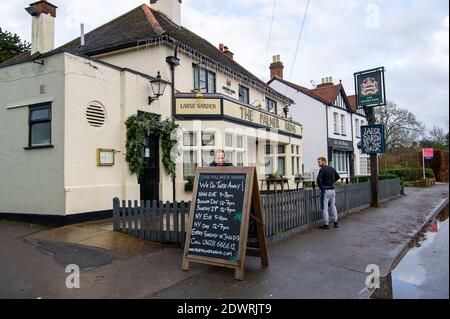 Dorney, Buckinghamshire, Regno Unito. 23 dicembre 2020. Chrys Fisher pub padrone del popolare pub del villaggio di Dorney il Palmer Arms, stava mettendo un segno oggi con i loro orari di apertura per i takeaways durante il Natale e il Capodanno. Anche se è stato un momento difficile per i pub e ristoranti a causa del Covid-19 Pandemic, molti proprietari di pub stanno mostrando la loro resilienza e sostenere i comuni locali in tutto il Covid-19 Pandemic. Credit: Maureen McLean/Alamy Live News Foto Stock