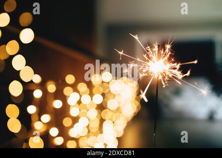 Scintillanti su luci di natale sfocate. Atmosfera festosa Foto Stock