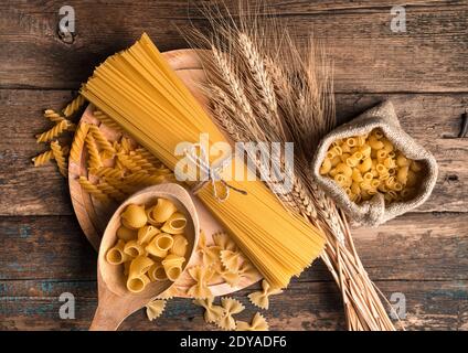 Pasta di diversi tipi su fondo ligneo. La vista dall'alto. Foto Stock