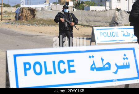 Al Wusta Governatorato, Oman. 25 Dic 2020. Gli ufficiali di polizia si levano in piedi in guardia ad un checkpoint su una strada vuota durante il lungo coprifuoco imposto per arginare alla diffusione del coronavirus COVID-19 pandemia nel Governatorato, il 25 dicembre 2020. (Foto di Mahmuod Khattab/INA Photo Agency/Sipa USA) Credit: Sipa USA/Alamy Live News Foto Stock