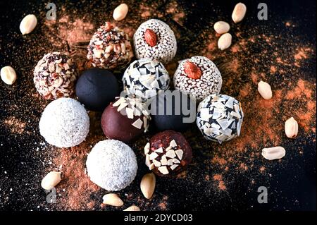 Composizione di caramelle rotonde fatte in casa in chiave scura. Sfere di energia organica sane. Foto Stock