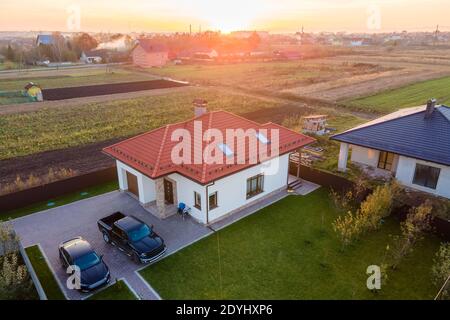 Vista aerea di una casa privata suburbana con auto parcheggiate nel cortile posteriore. Foto Stock