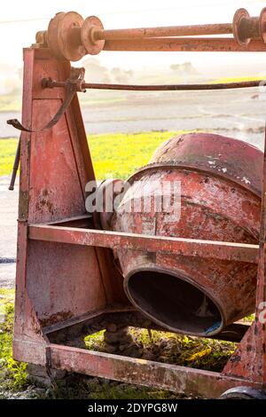 Vecchio Rusty abbandonato macchina betoniera accanto alla strada in un villaggio Foto Stock